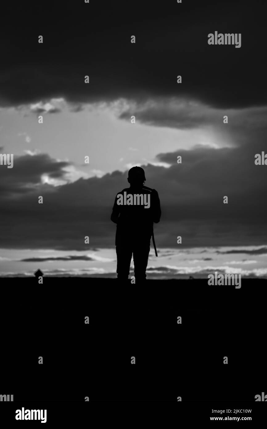 Grayscale photo of man standing near window photo – Free Cloud