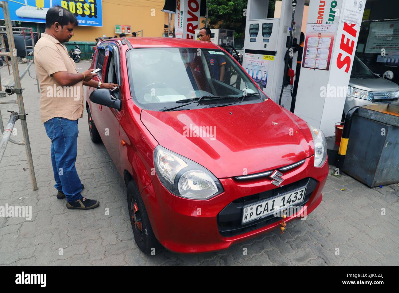 Colombo, Sri Lanka. 1st Aug, 2022. A man checks the national fuel pass at a gas station in