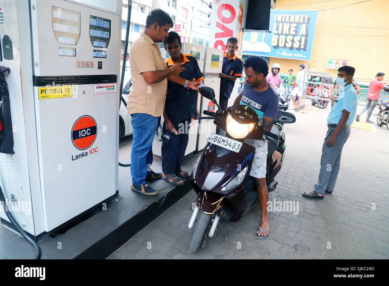 Colombo, Sri Lanka. 1st Aug, 2022. A man checks the national fuel pass at a gas station in
