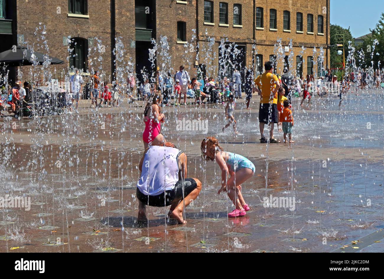 Summer bathers, having fun, at Granary Square, Kings Cross, coal drops Yard, Camden, North London, England, UK, N1C 4BH Stock Photo