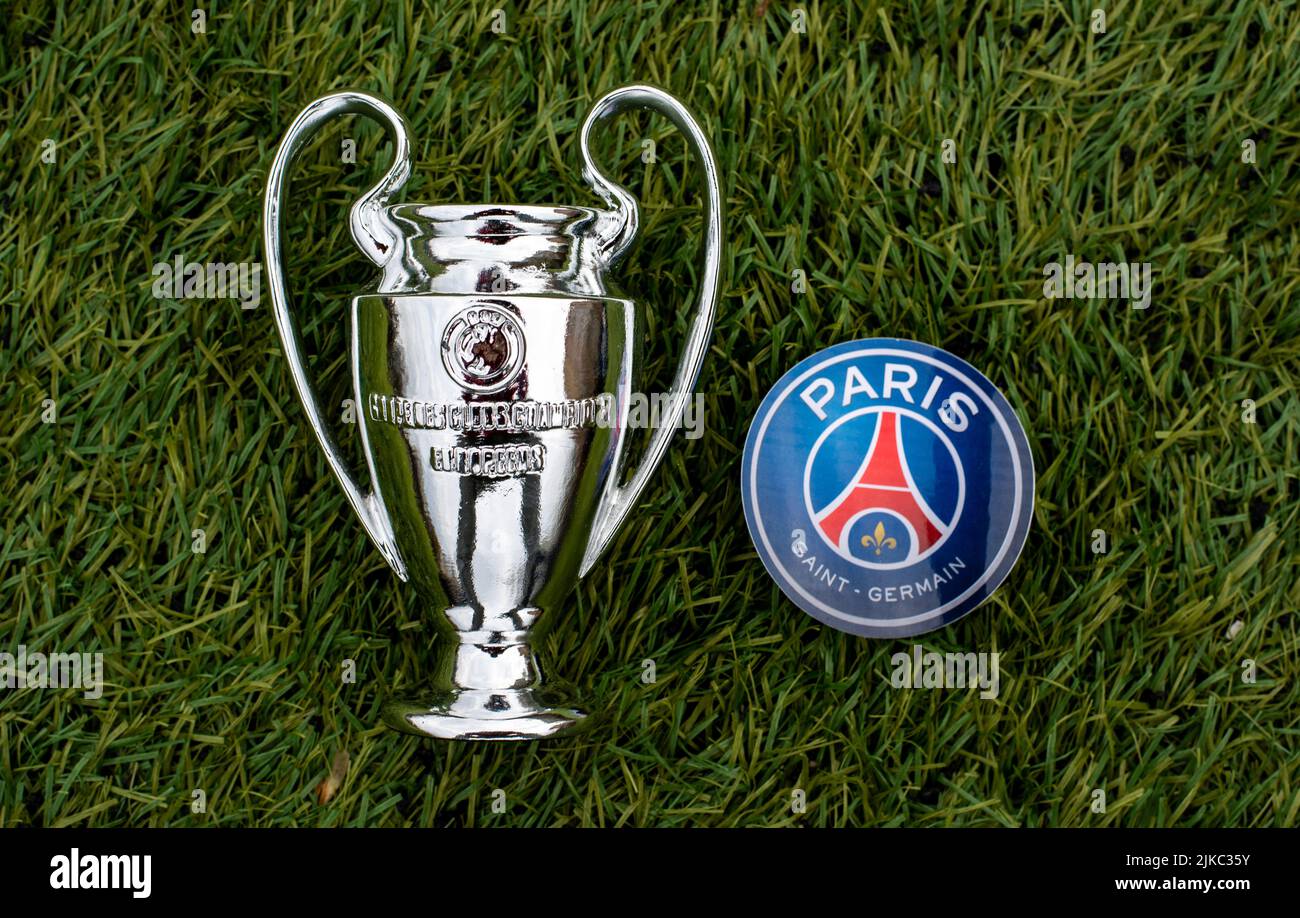 April 21, 2021, Moscow, Russia. The emblem of the football club Paris Saint-Germain F.C. and the UEFA Champions League Cup on the green grass of the s Stock Photo