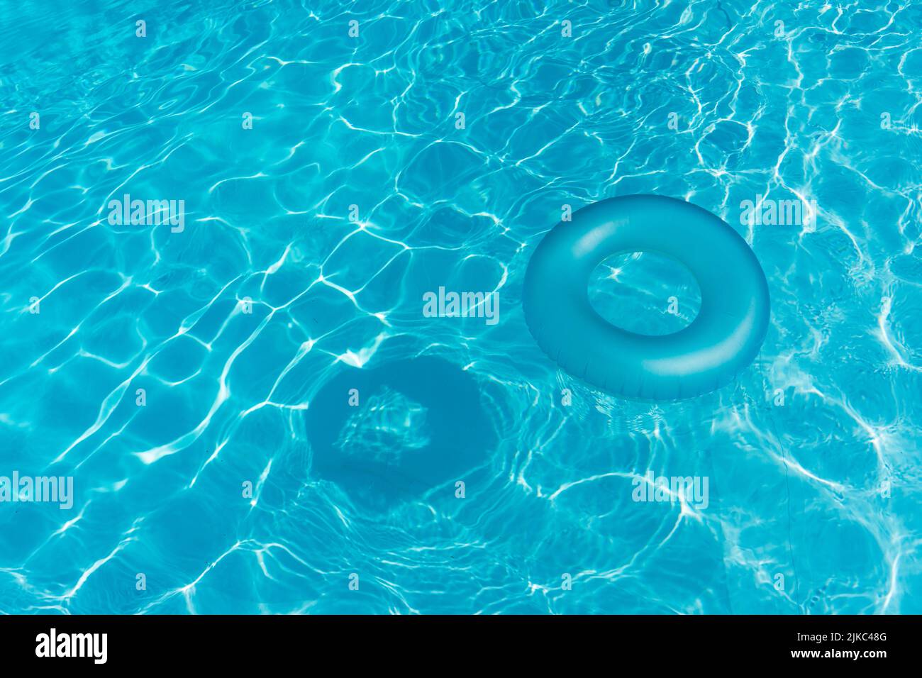 Blue summer pool rubber ring floating on a vacation swimming pool Stock