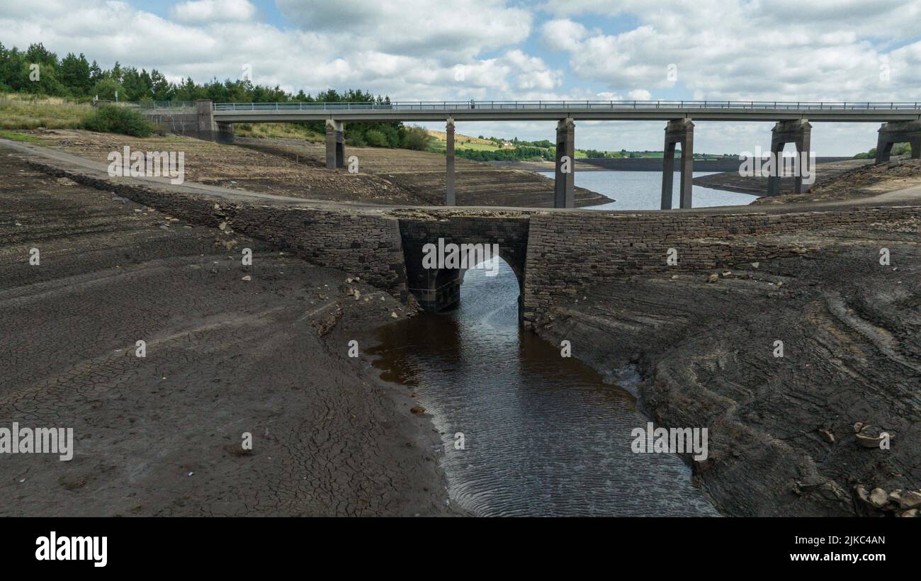 Ripponden, UK. 01st Aug, 2022. Remnants of an old bridge that's usual submerged under water is full exposed as water in the reservoir is severally depleted at Baitings Reservoir near Ripponden West Yorkshire, UK on the 01/08/2022 in Ripponden, United Kingdom on 8/1/2022. (Photo by Mark Cosgrove/News Images/Sipa USA) Credit: Sipa USA/Alamy Live News Stock Photo