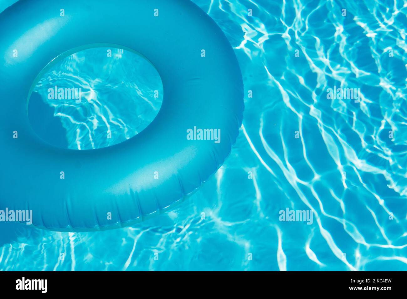 Blue summer pool rubber ring floating on a vacation swimming pool Stock