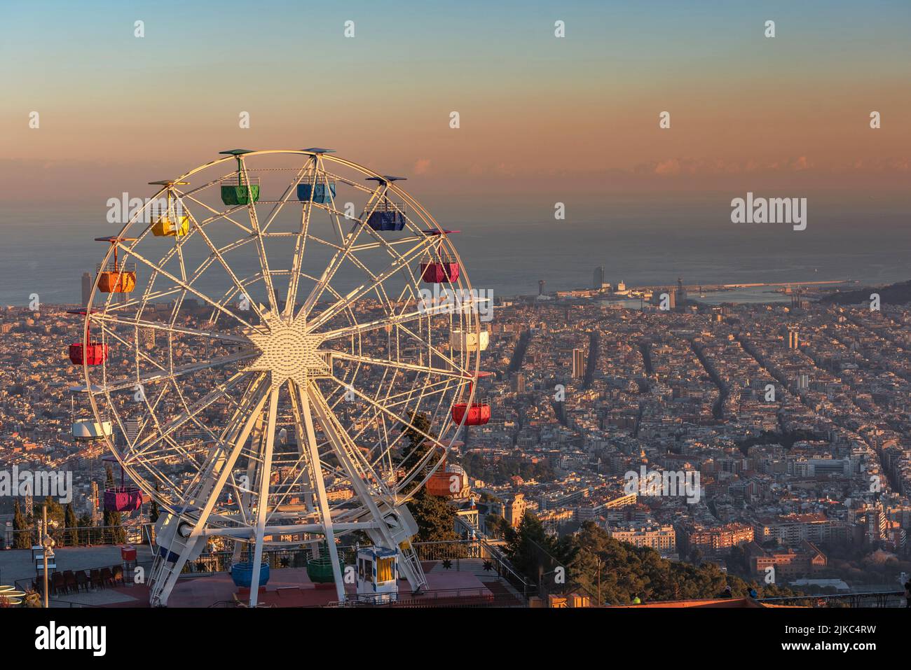 Ferris wheel on Tibidabo hill Barcelona at sunset Stock Photo