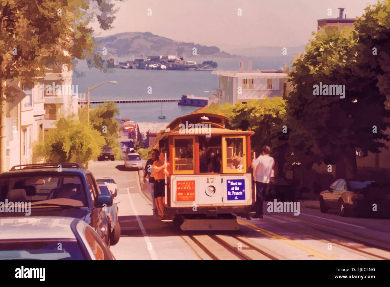 Cable car climbing a street in San Francisco, with Alcatraz island in the distance. Stock Photo
