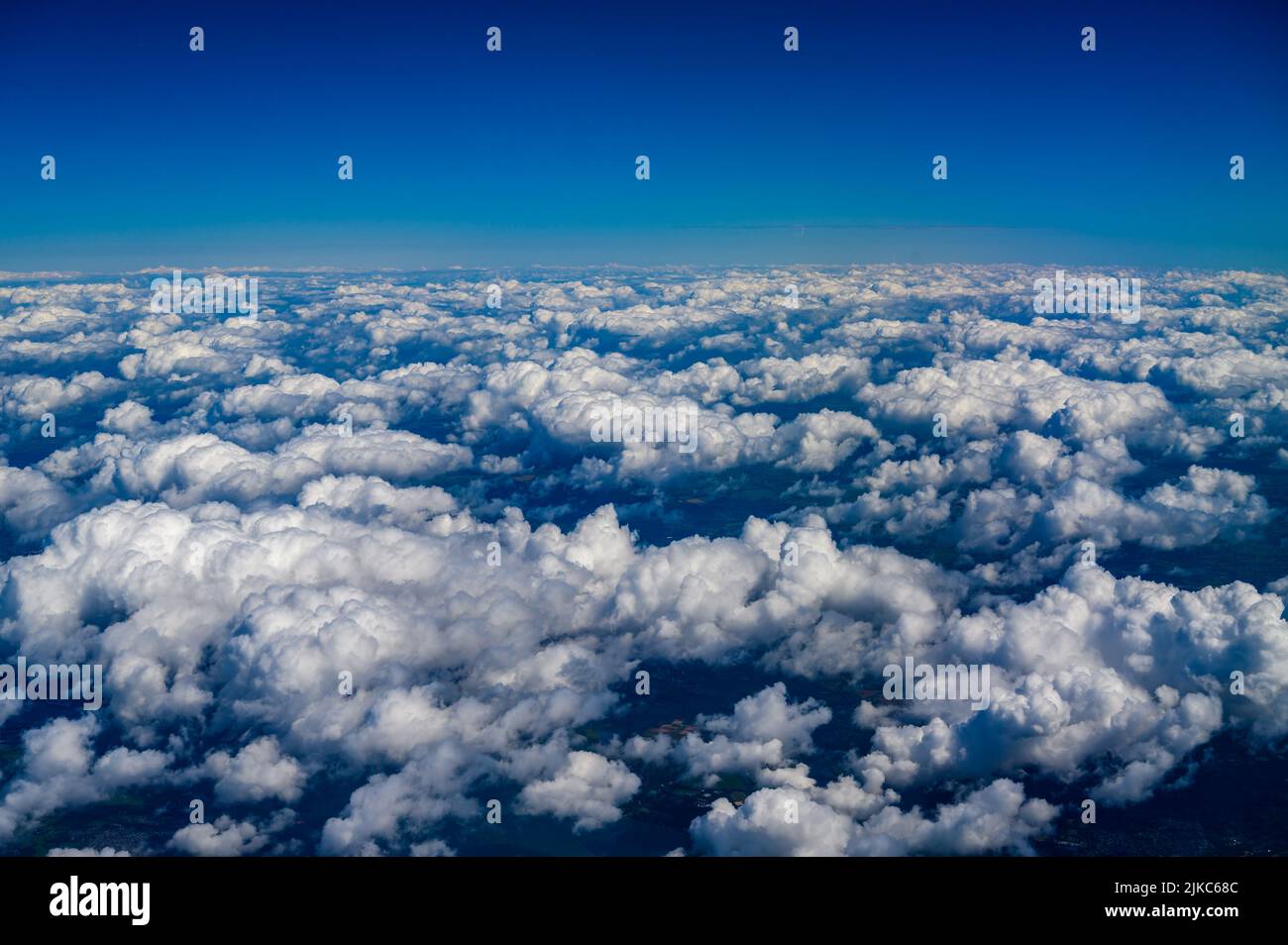 Aerial view over south coast of England from above white cumulus clouds photographed from a passenger jet. Stock Photo