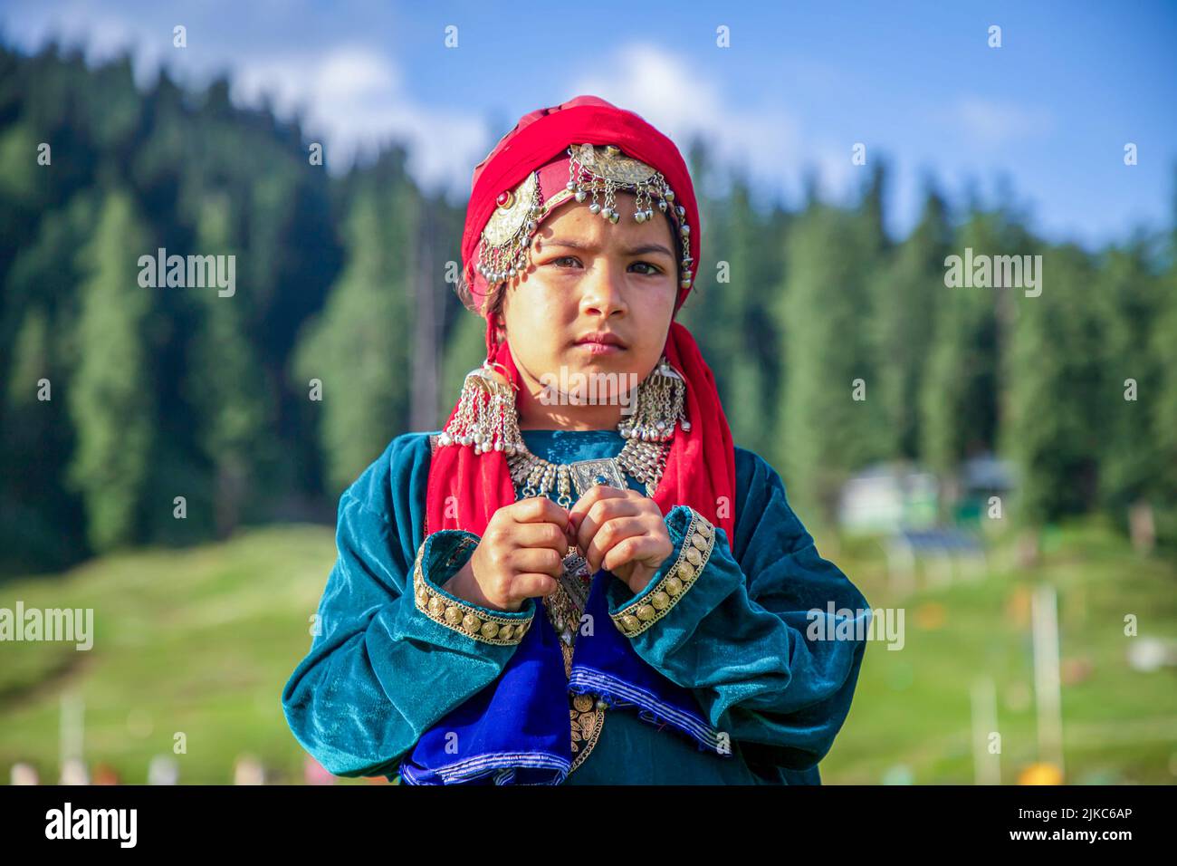A girl dressed in a traditional Kashmiri dress poses for a photo on a sunny day at famous tourist resort Gulmarg in Northern Kashmir s Baramulla district. Gulmarg is the crowning glory of