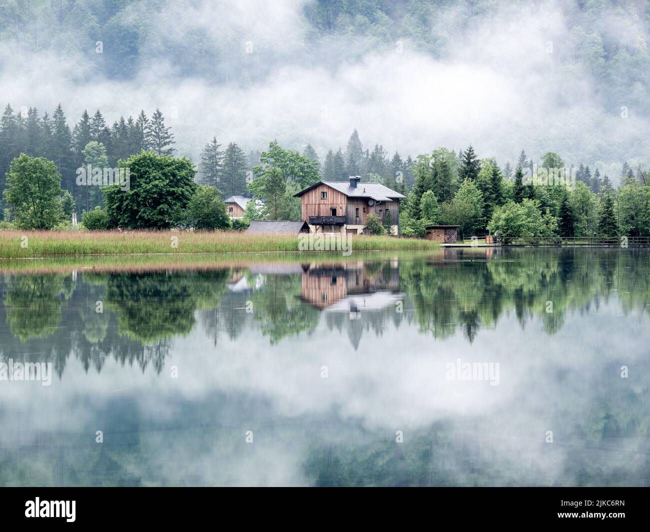 A house on the shore of Lake Alm in Grunau im Almtal, Austria Stock Photo