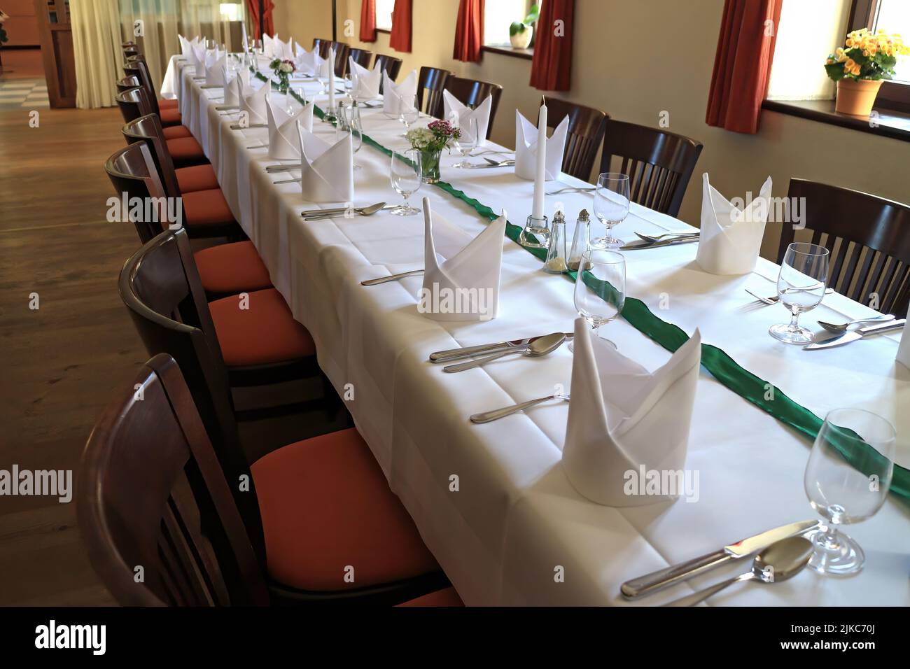 Long festive decorated table with white tablecloth Stock Photo