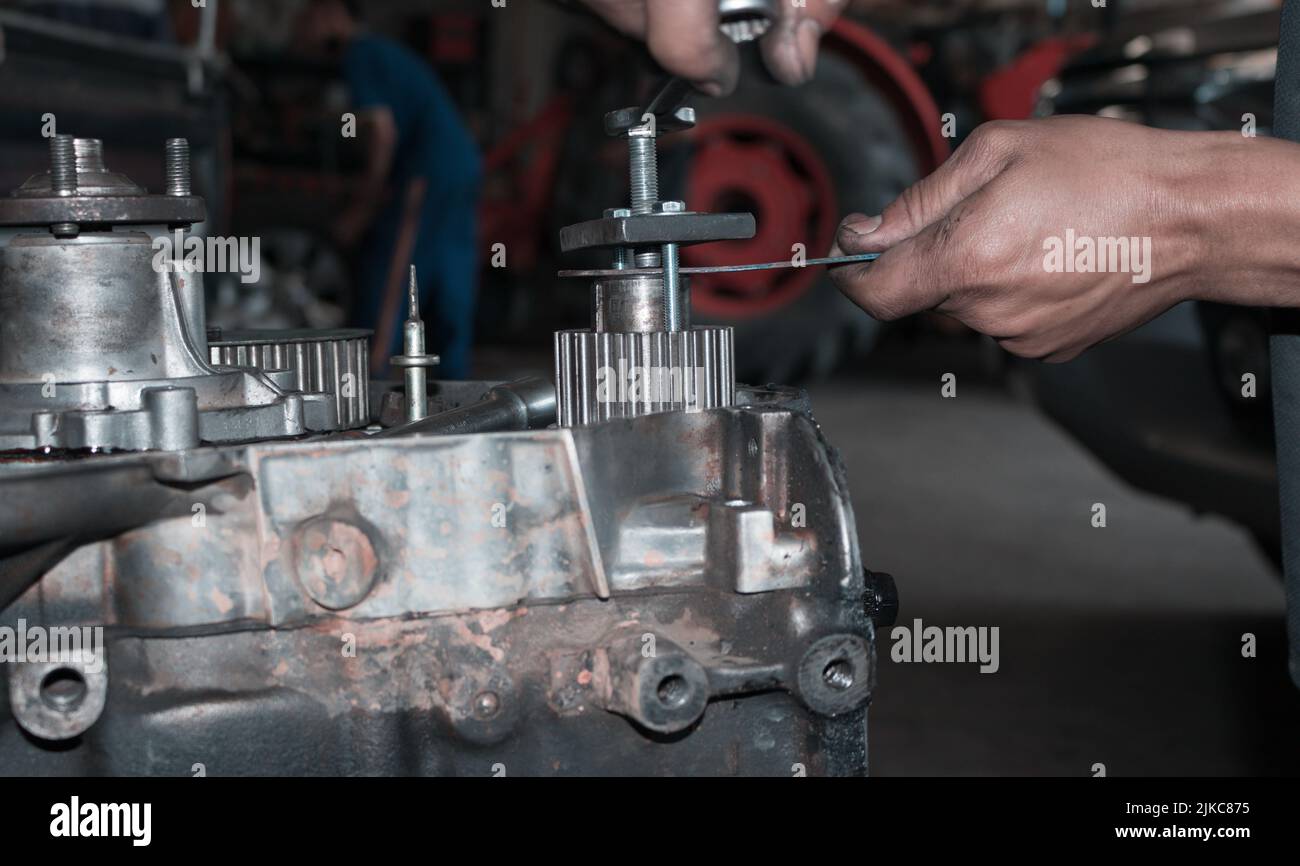 a close up of auto mechanic's hands repairing car troubleshooting with
