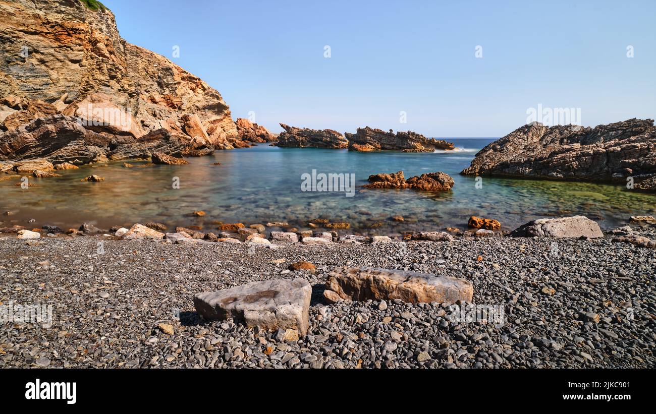 Rocks and sea in long exposure in Menorca, Spain Stock Photo - Alamy