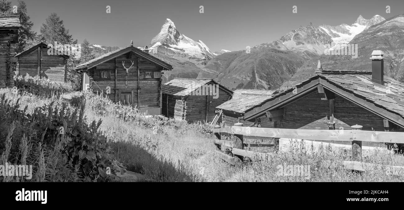 The panorama of swiss walliser alps with the Matterhorn peak with the typical chalets. Stock Photo