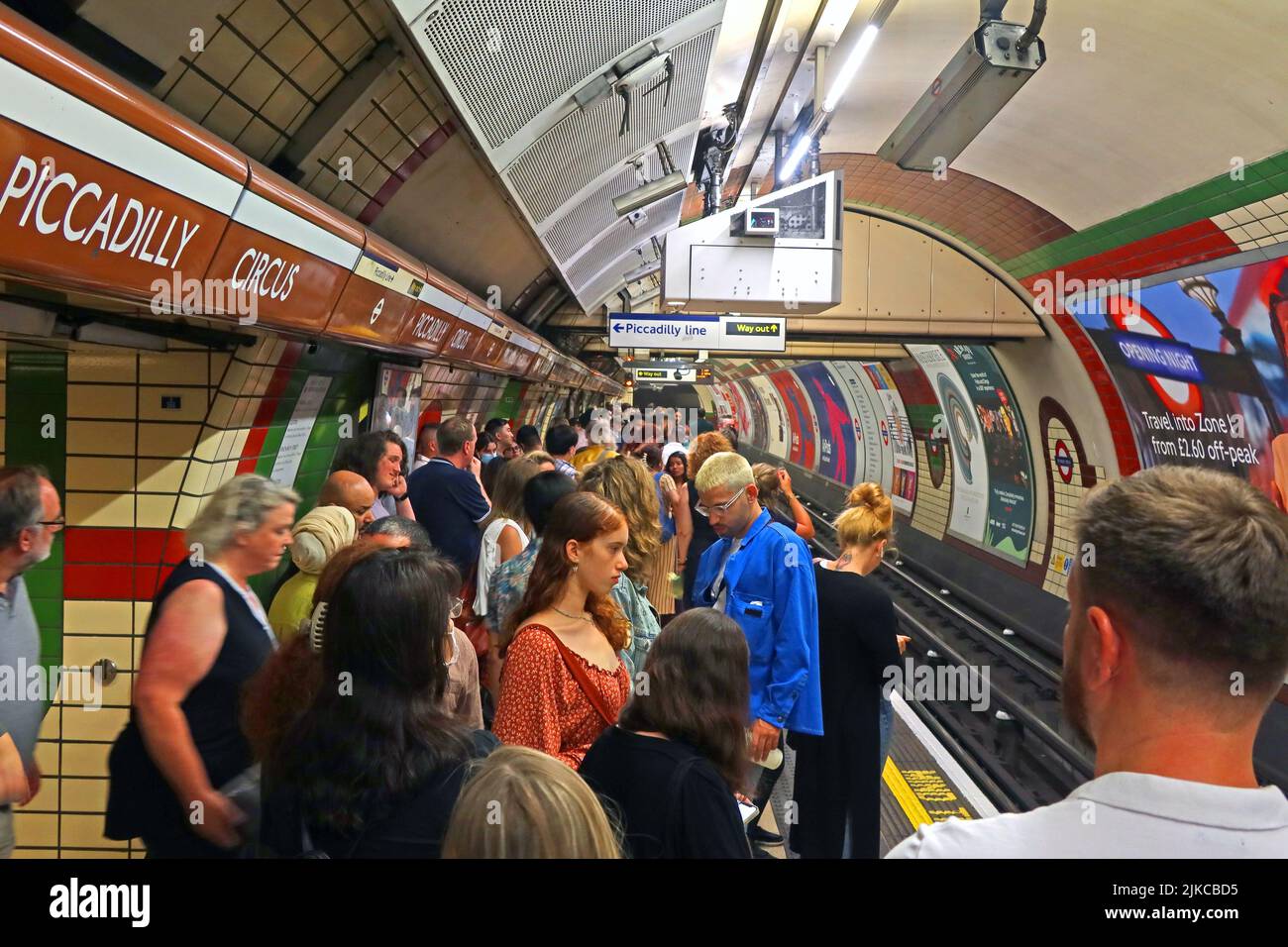 Crowded and busy Bakerloo tube platform, at Piccadilly Circus tube station, London, England, UK Stock Photo