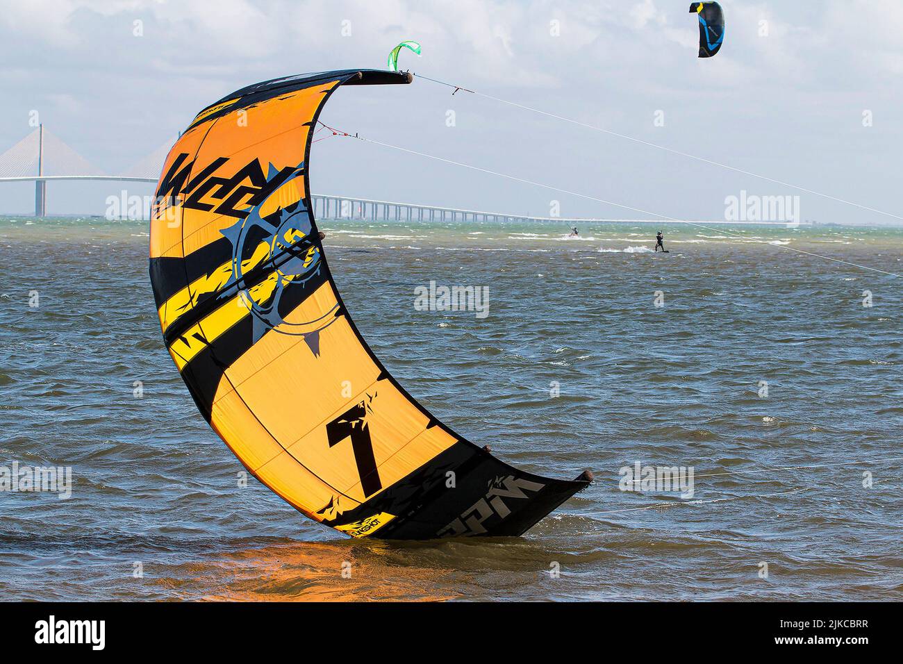 An orange kite touching the water during kitesurfing Stock Photo Alamy