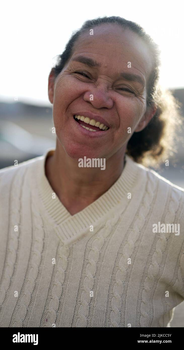 A happy latin senior woman smiling at camera. Portrait of a Brazilian ...