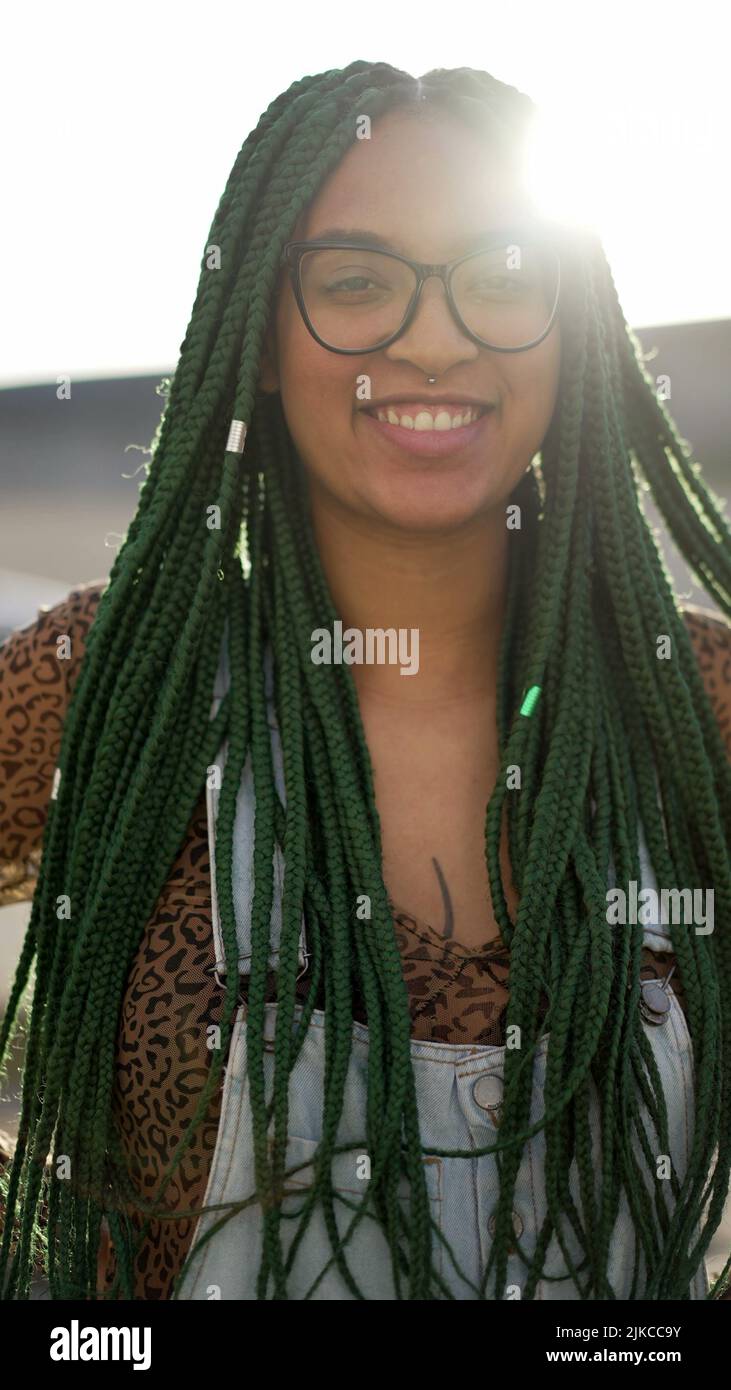 A happy black latin girl with green Box Braids hairstyle smiling at camera  Stock Photo  Alamy
