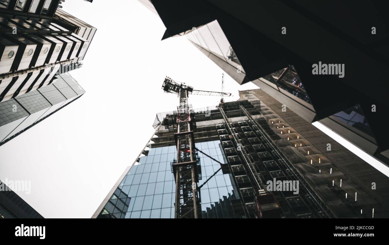 A low angle shot of modern buildings under construction with big ...