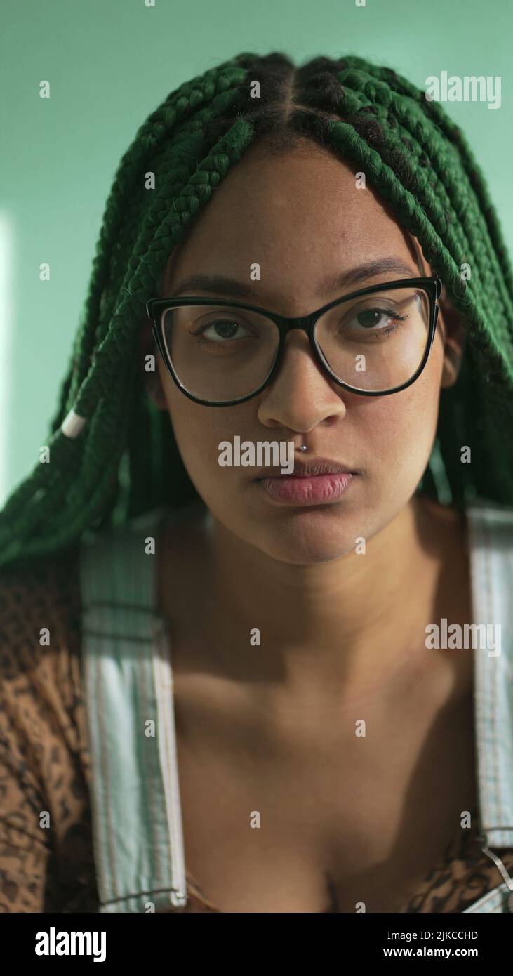 Portrait of a hispanic latina black girl with green dreadlocks box