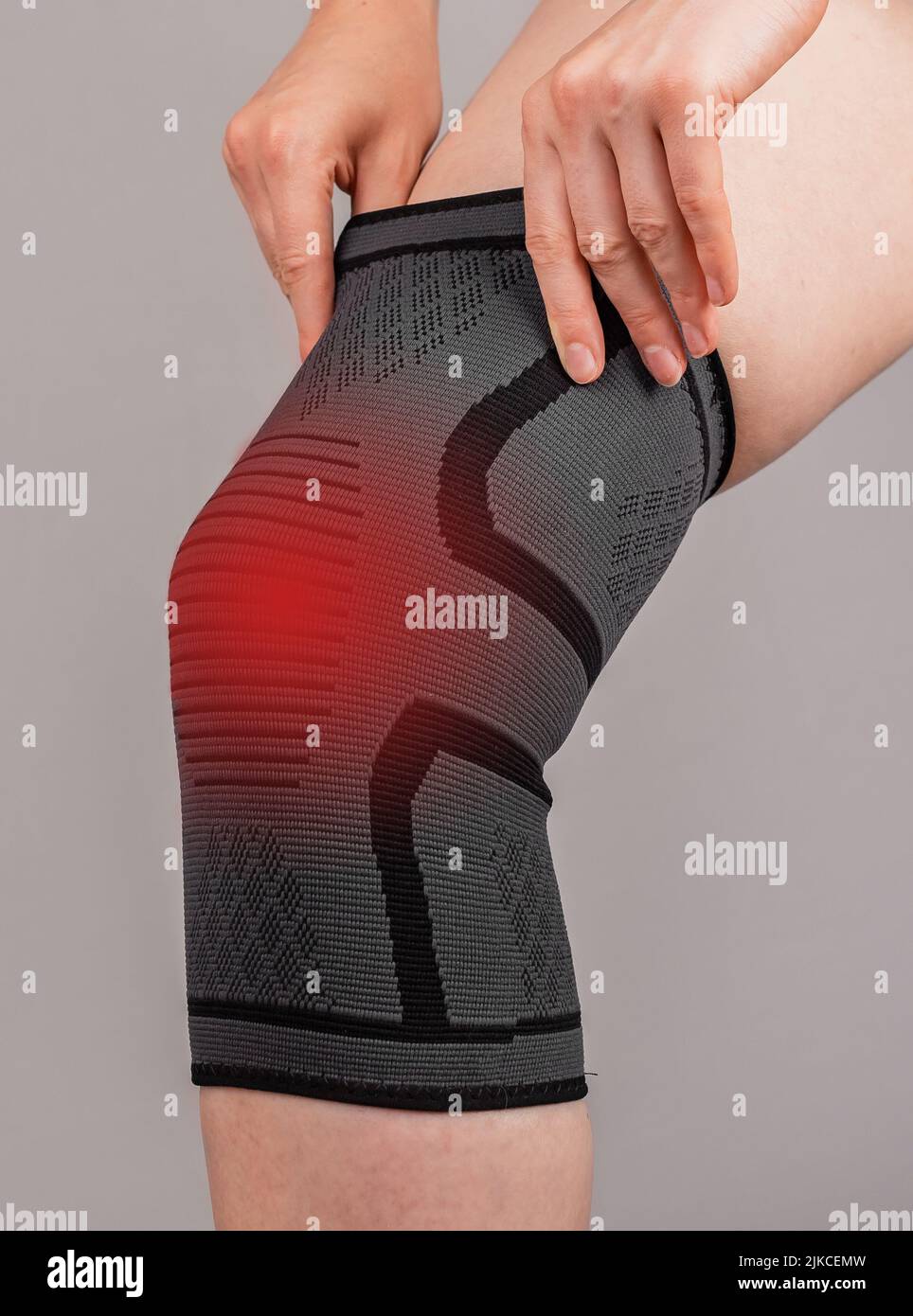 Woman wearing knee brace to reduce pain. Female leg with red spot