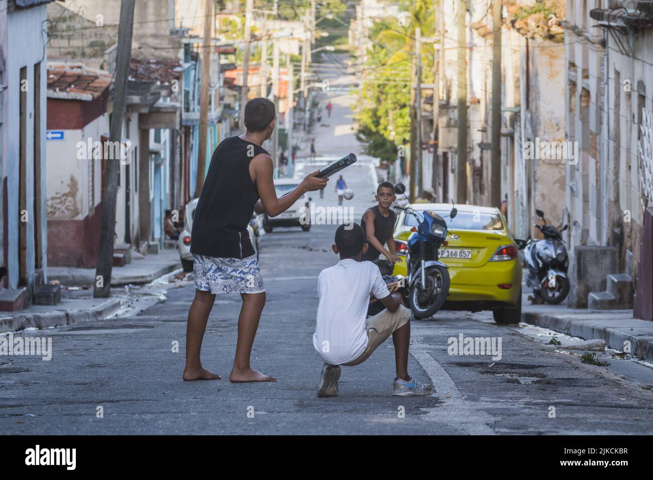 The little boys playing baseball on the streets of Matanzas, Cuba Stock Photo