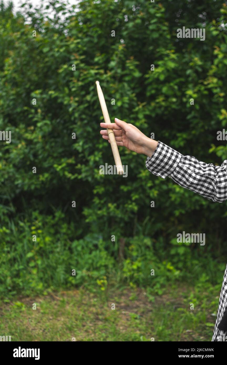 Young girl musician drummer hand twirling drumstick Stock Photo Alamy