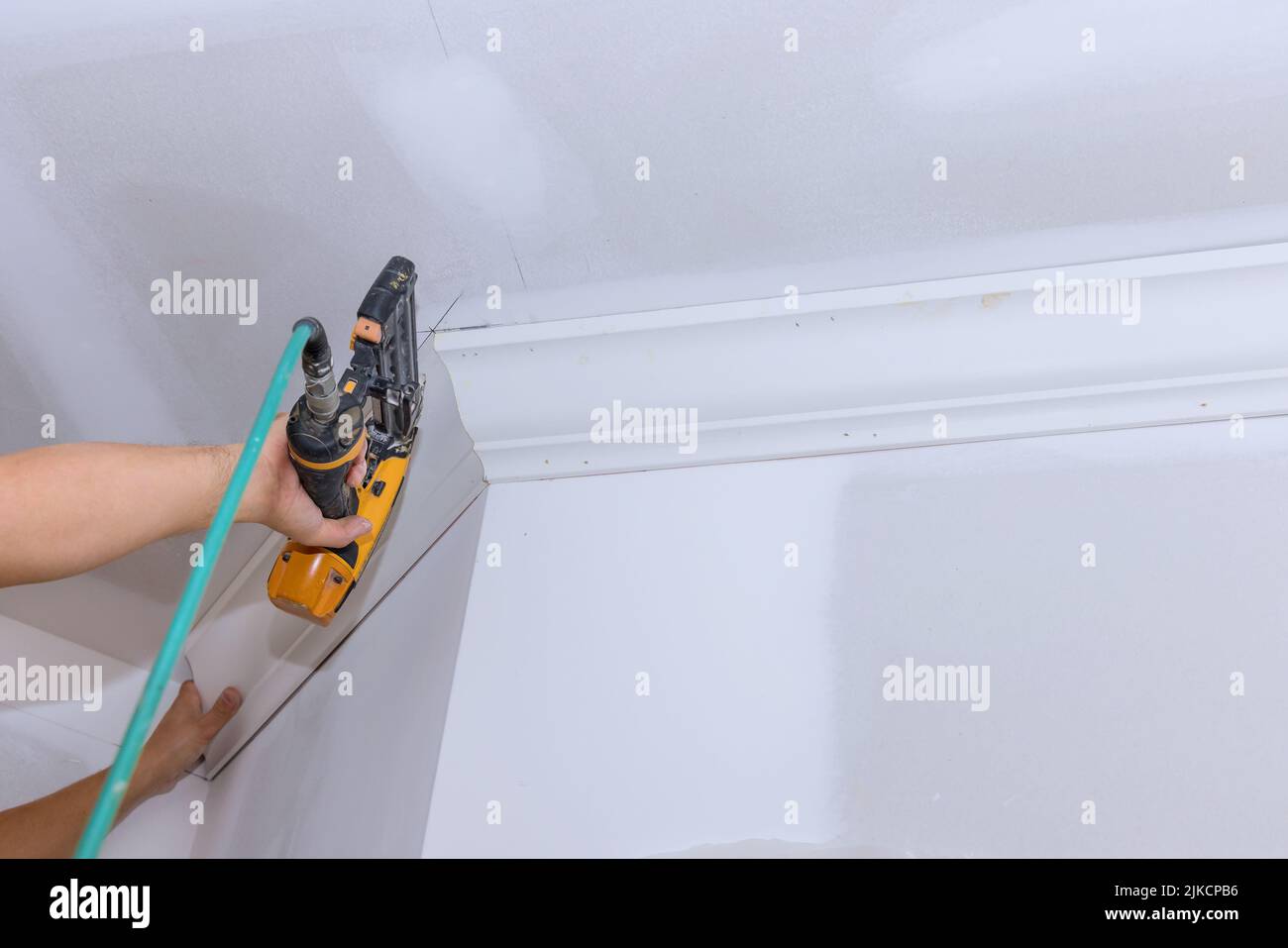 An air nail gun was used by the carpenter to install the ceiling corner
