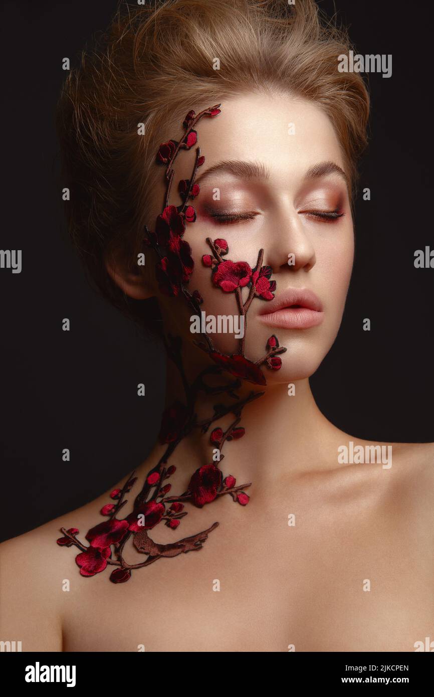 Young woman with flower makeup Stock Photo