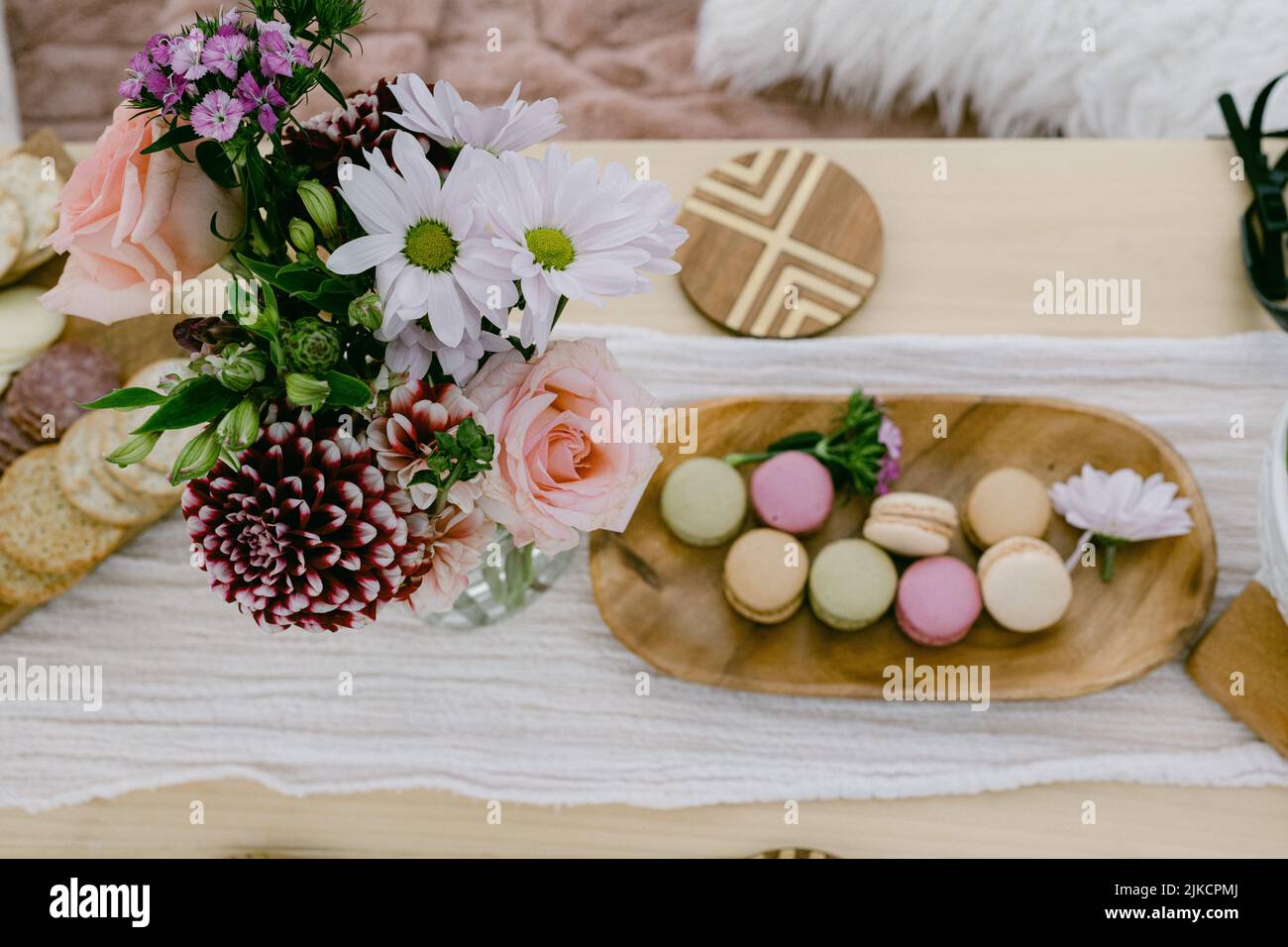 flowers and macarons on a wooden table Stock Photo