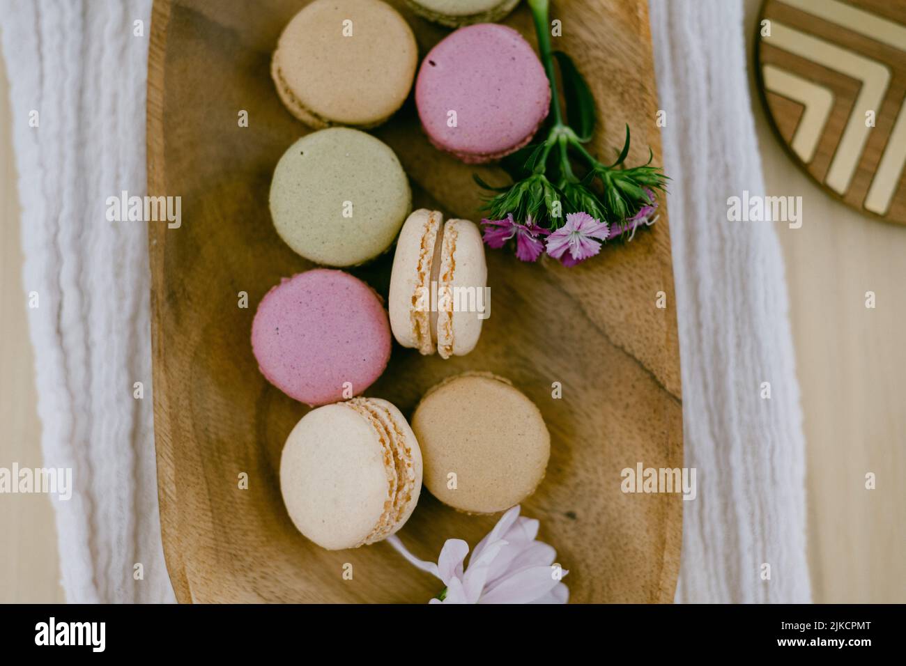 colorful macarons on a wooden plate Stock Photo