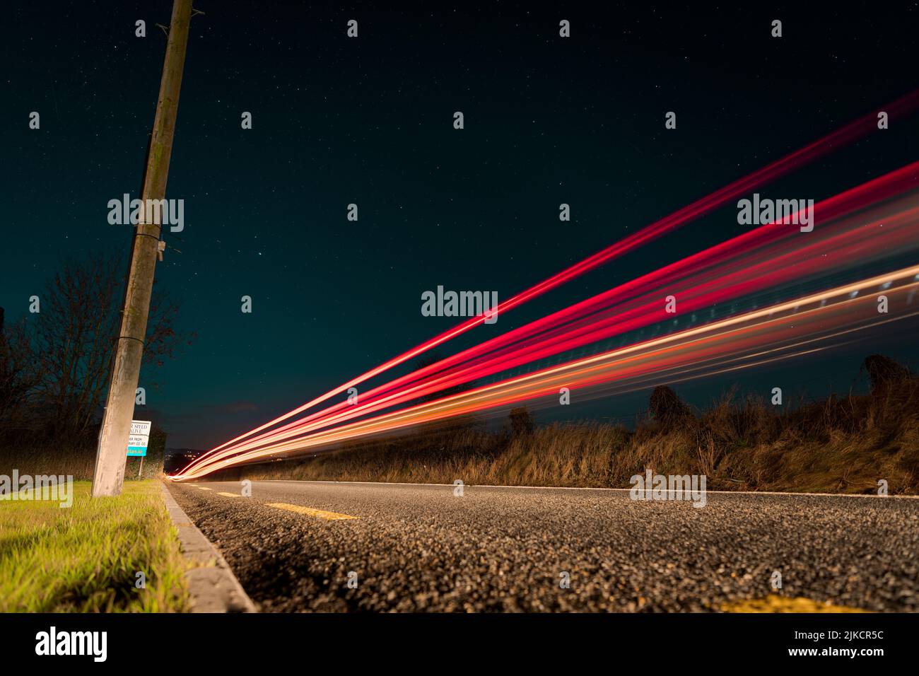 A low angle of traffic lights at night shot in long exposure Stock