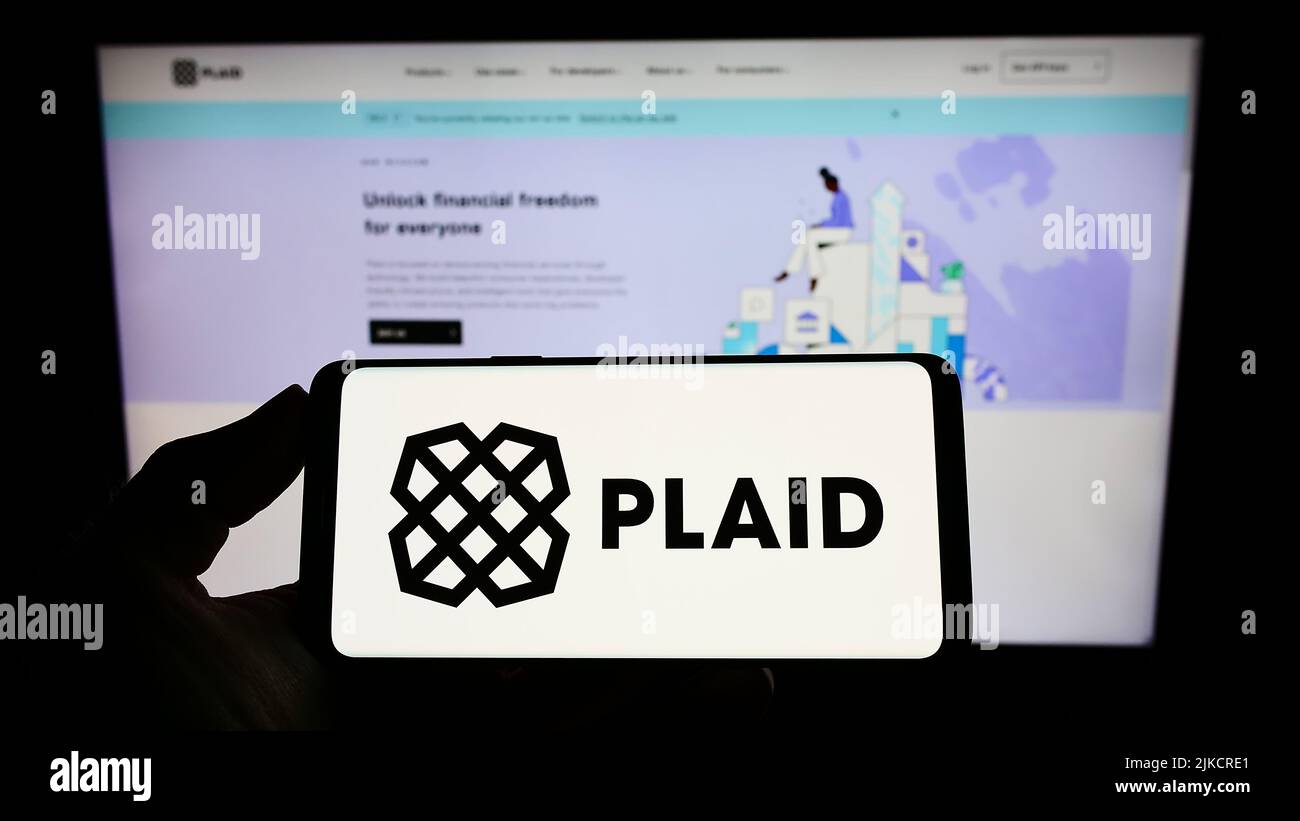 Person holding smartphone with logo of US fintech company Plaid Inc. on  screen in front of website. Focus on phone display Stock Photo - Alamy
