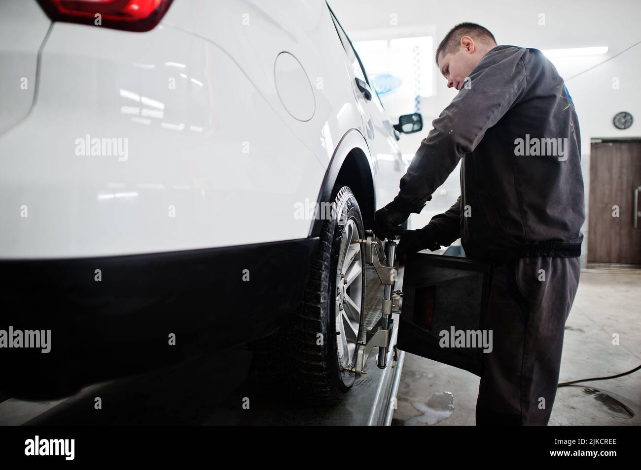 Auto mechanic sets american SUV car for diagnostics and configuration ...