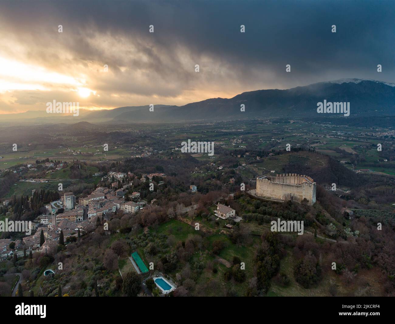 An aerial view of a sunset sky over Asolo Fortress in the hills Stock Photo