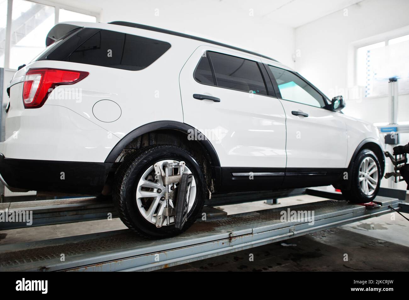 American SUV car on stand for wheels alignment camber check in