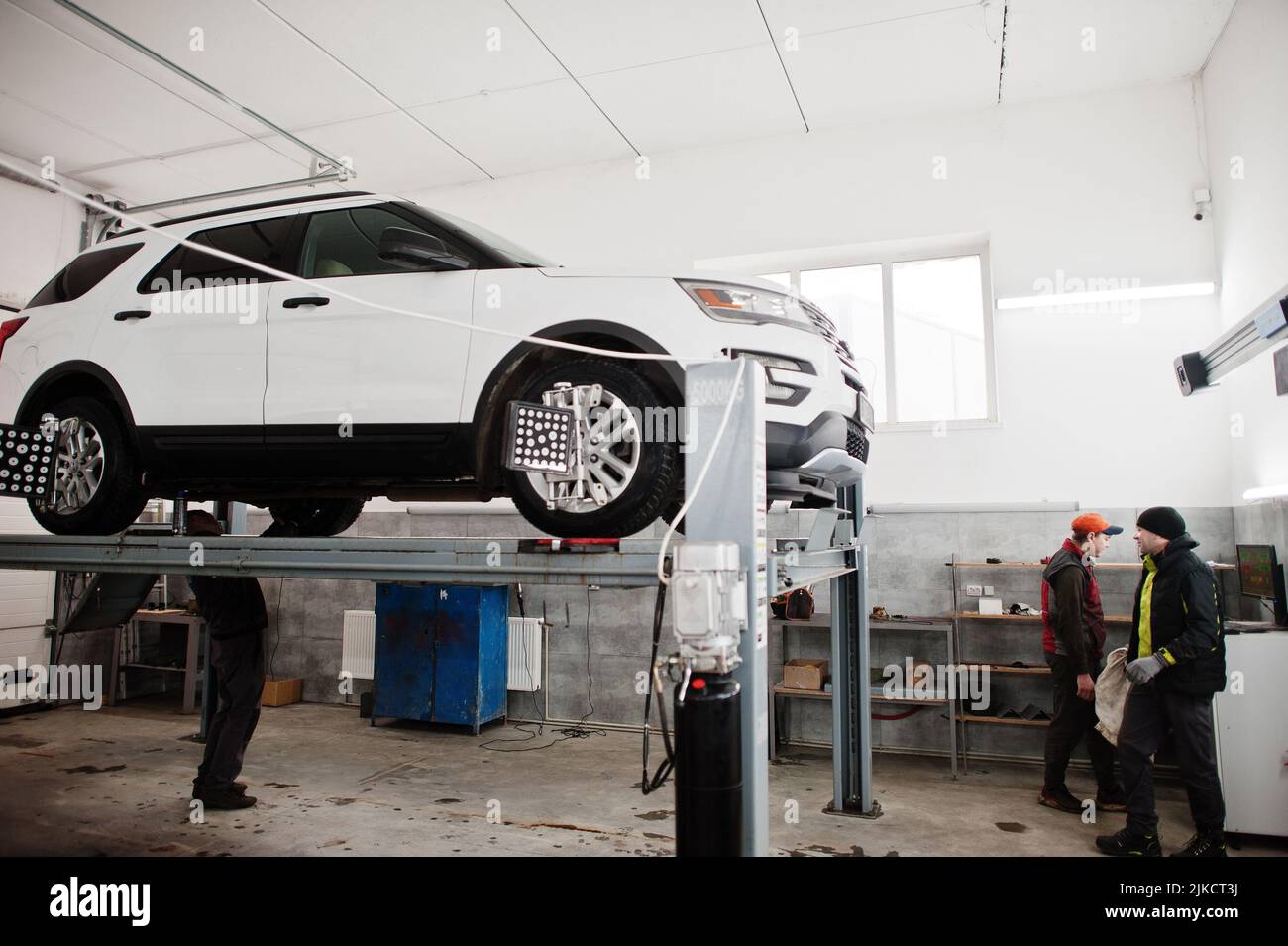 American SUV car on stand for wheels alignment camber check in