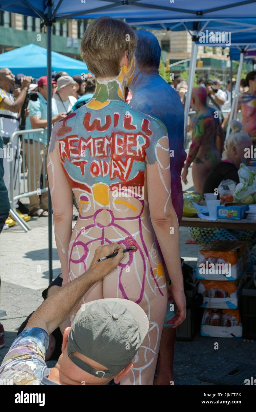 A rear view of an unidentifiable slender young lady at NYC Body Painting Day in Union Square Park in Lower Manhattan, New York. Stock Photo