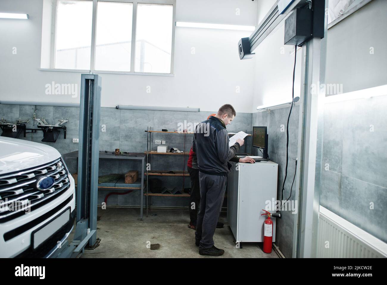 Auto mechanic sets american SUV car for diagnostics and configuration ...