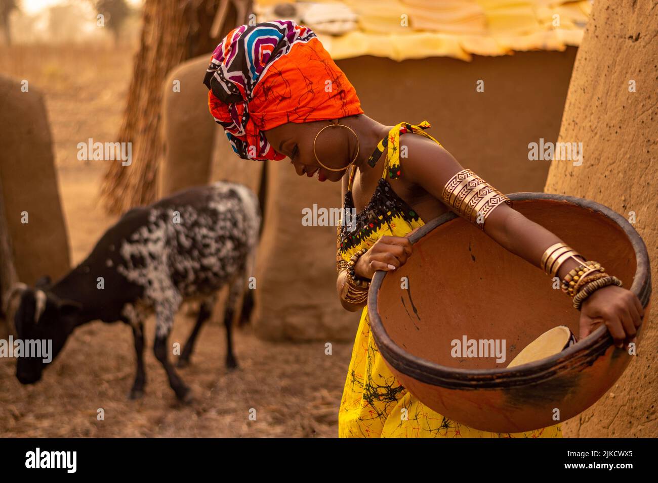 a model poses in a traditional home setting in northern ghana Stock Photo