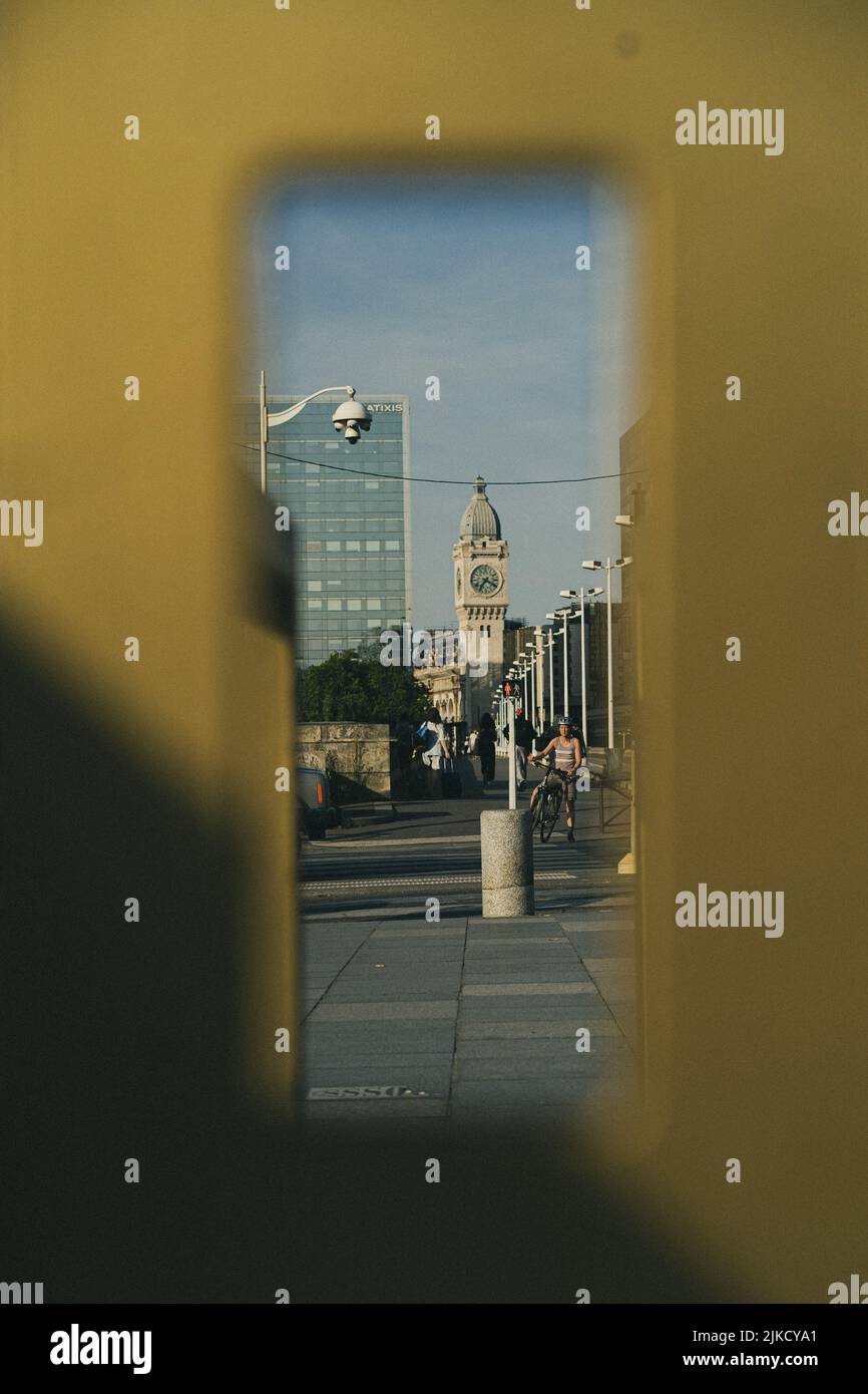 A vertical shot of a cityscape with clock tower and passers-by Stock ...