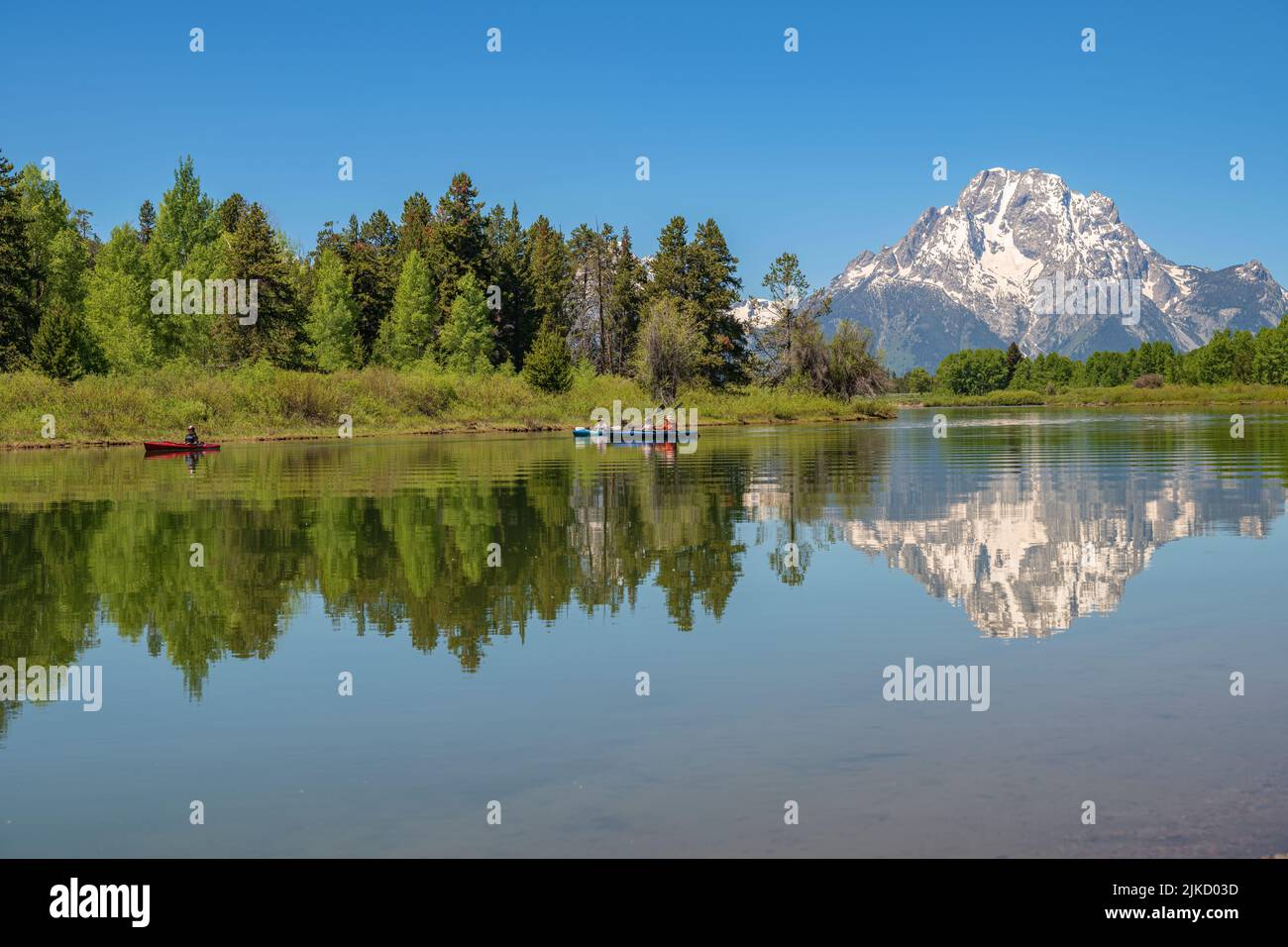 Jenny Lake kayakers and the tetons mountains wilderness. Stock Photo