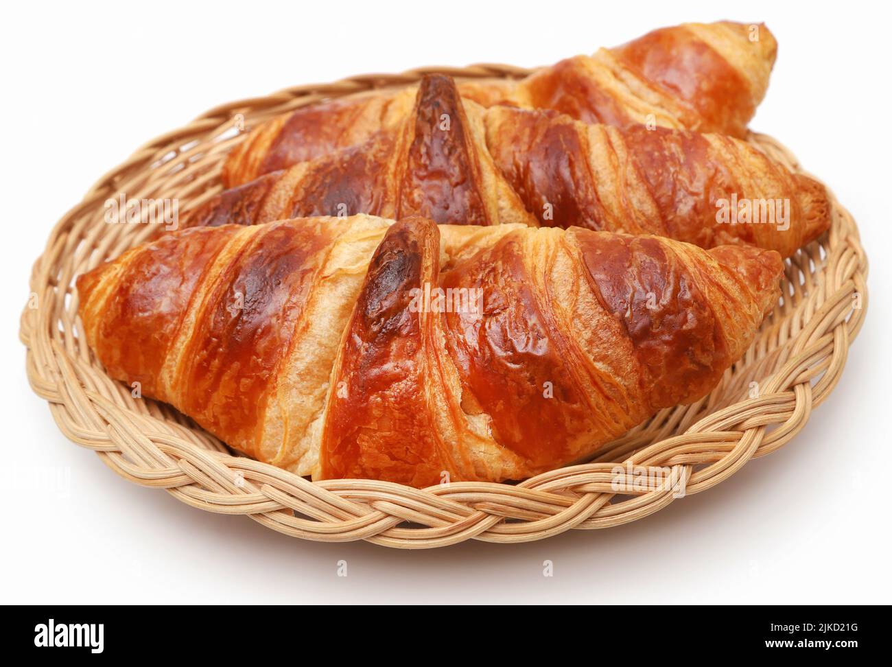 Closeup of tasty croissant in a basket over white background Stock Photo