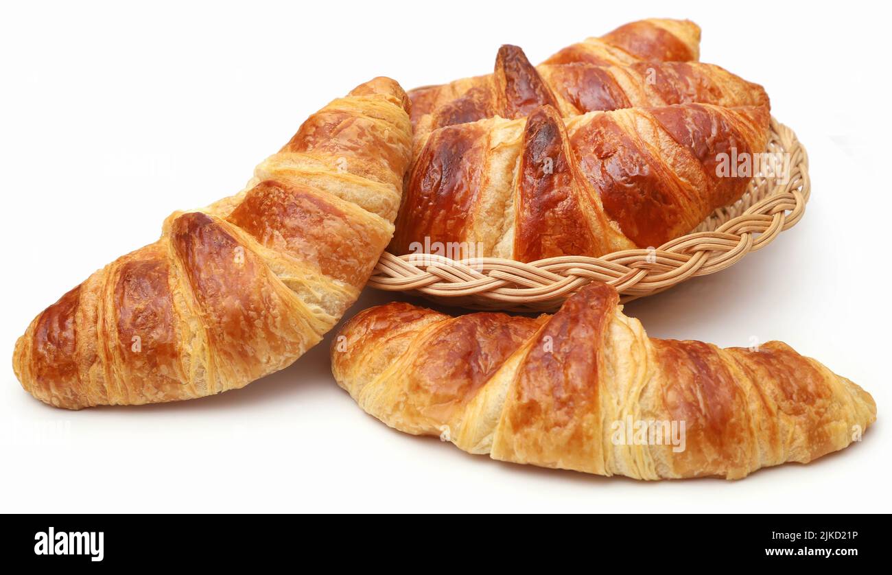 Closeup of tasty croissant in a basket over white background Stock Photo