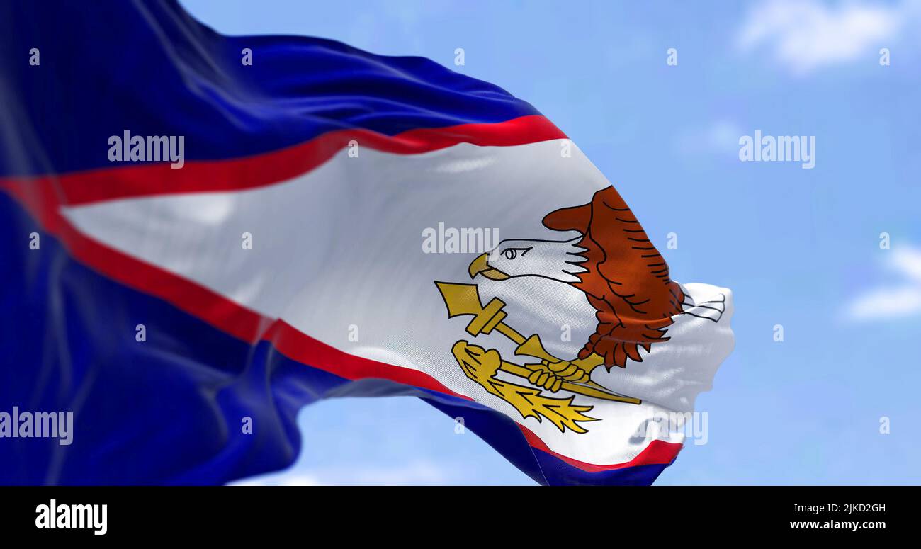 The American Samoa flag in the wind on a clear day. American Samoa is an unincorporated territory of the United States located in the South Pacific Oc Stock Photo