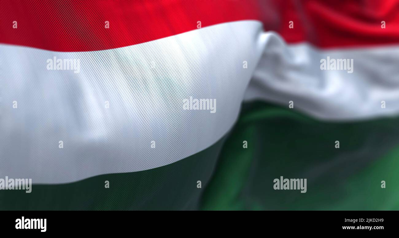 Close-up view of the Hungary national flag waving in the wind. Hungary is a landlocked country in Central Europe. Fabric textured background. Selectiv Stock Photo