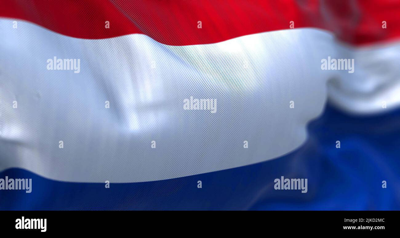 Close-up view of the Netherlands national flag waving in the wind. The Netherlands is a country located in Northwestern Europe. Fabric texture backgro Stock Photo