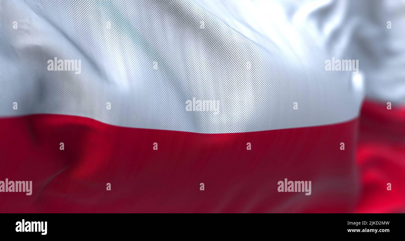 Close-up view of the Poland national flag waving in the wind. Poland is a country in Central Europe. Fabric textured background. Selective focus Stock Photo