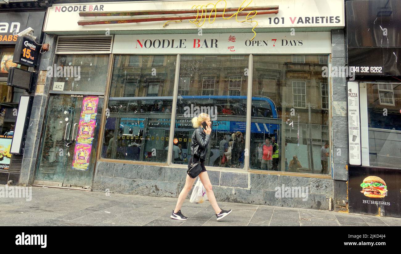 Glasgow, Scotland, UK 1st August, 2022. Sad Sauchiehall street was once the golden mile of shopping in scotland and its demise was accelerated after the abc and school of art fires. The street became takeaways and charity shops now even these are leaving. A council initiative sees painting over graffiti boards and attreacive graphics where shops should be. Much like what was tried in pasley, it failed. Credit Gerard Ferry/Alamy Live News Stock Photo