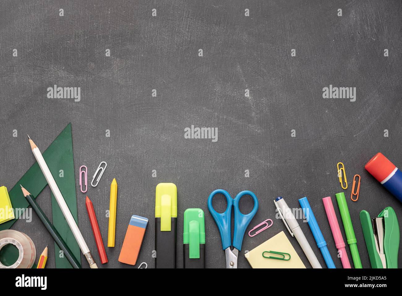 Back to school background with copy space. Variety of Office and school supplies on Blackboard background Stock Photo