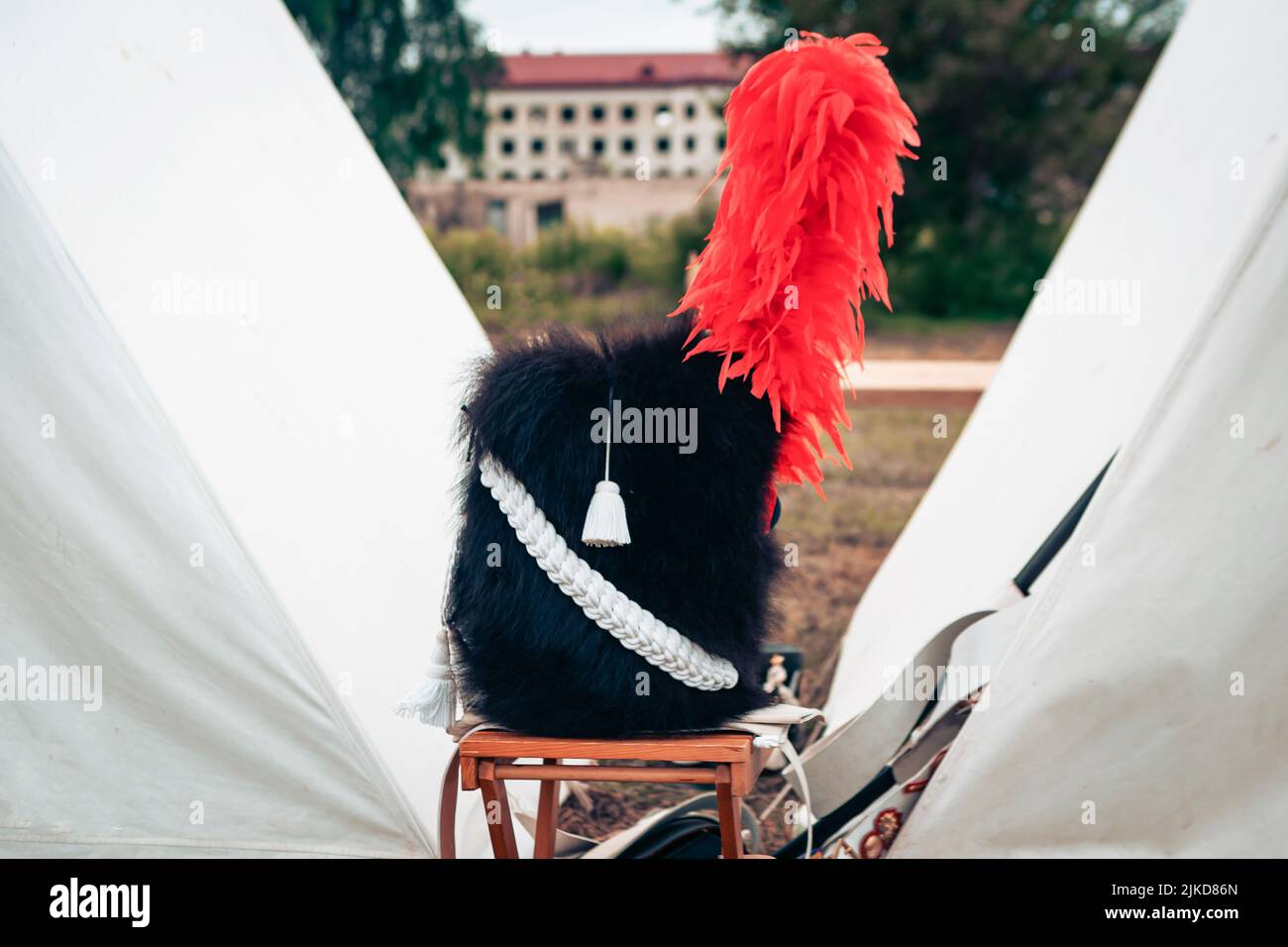Hat of a soldier of the Napoleonic army with red feather, close up